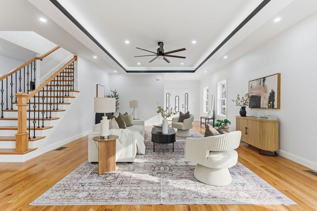 251 Clark Road Lowell, MA 01852 - Photo 6 of 36 a living room with fireplace furniture rug and wooden floor