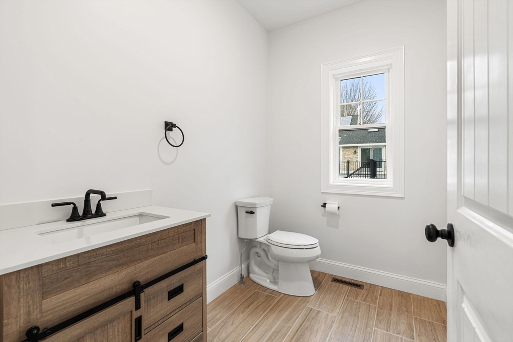 251 Clark Road Lowell, MA 01852 - Photo 8 of 36 a bathroom with a sink a toilet and a window