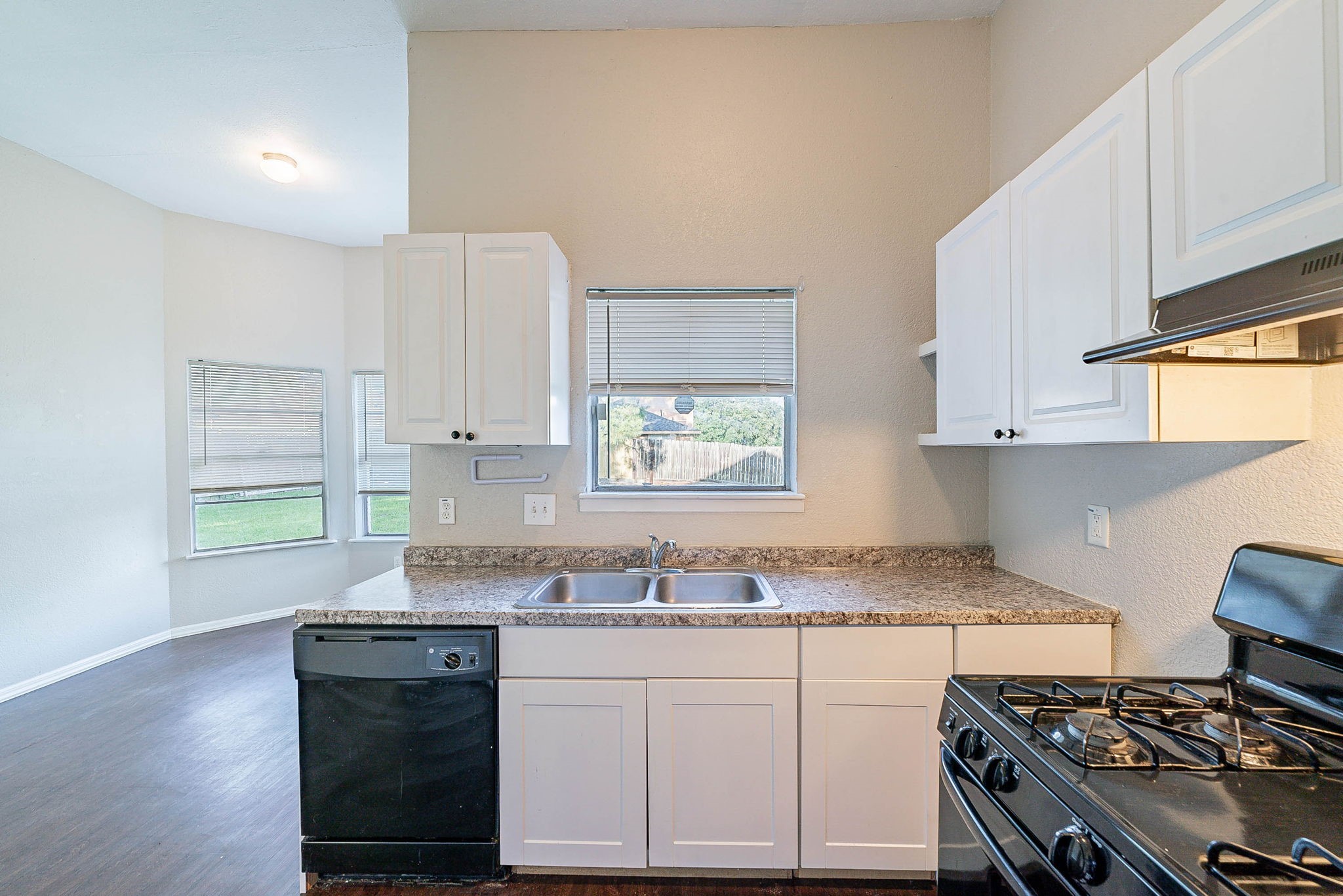 1502 Stevenage Lane Channelview, TX 77530 - Photo 12 of 33 a kitchen with granite countertop a stove a sink and a window