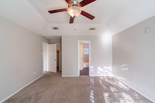 a view of empty room with ceiling fan