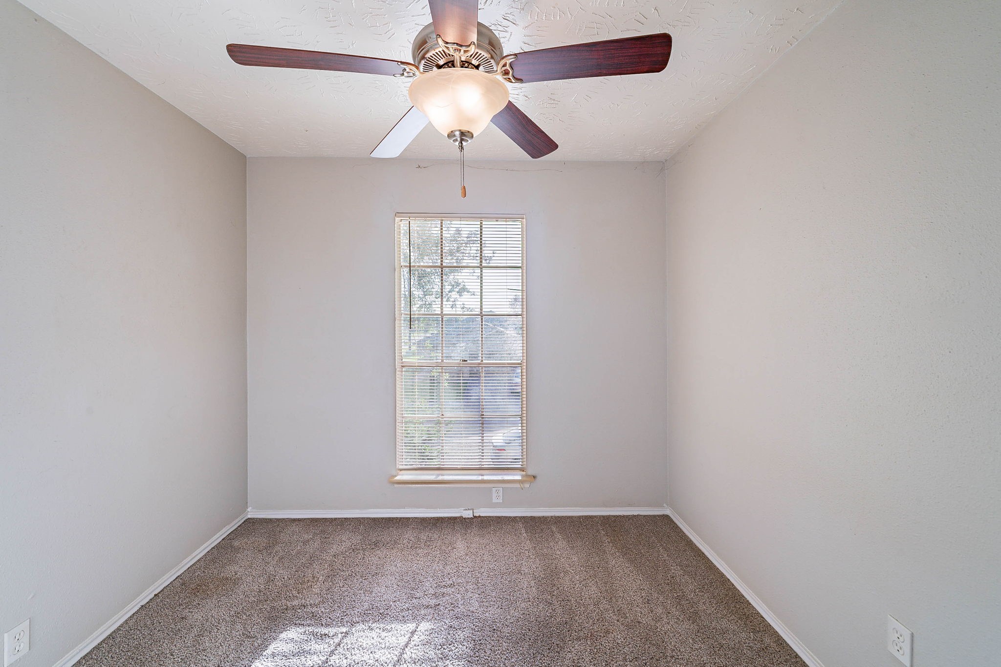 1502 Stevenage Lane Channelview, TX 77530 - Photo 25 of 33 an empty room with windows and fan