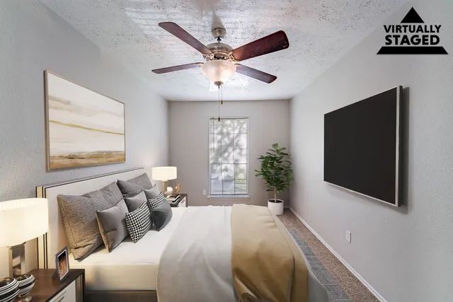 a view of a room with a ceiling fan and windows