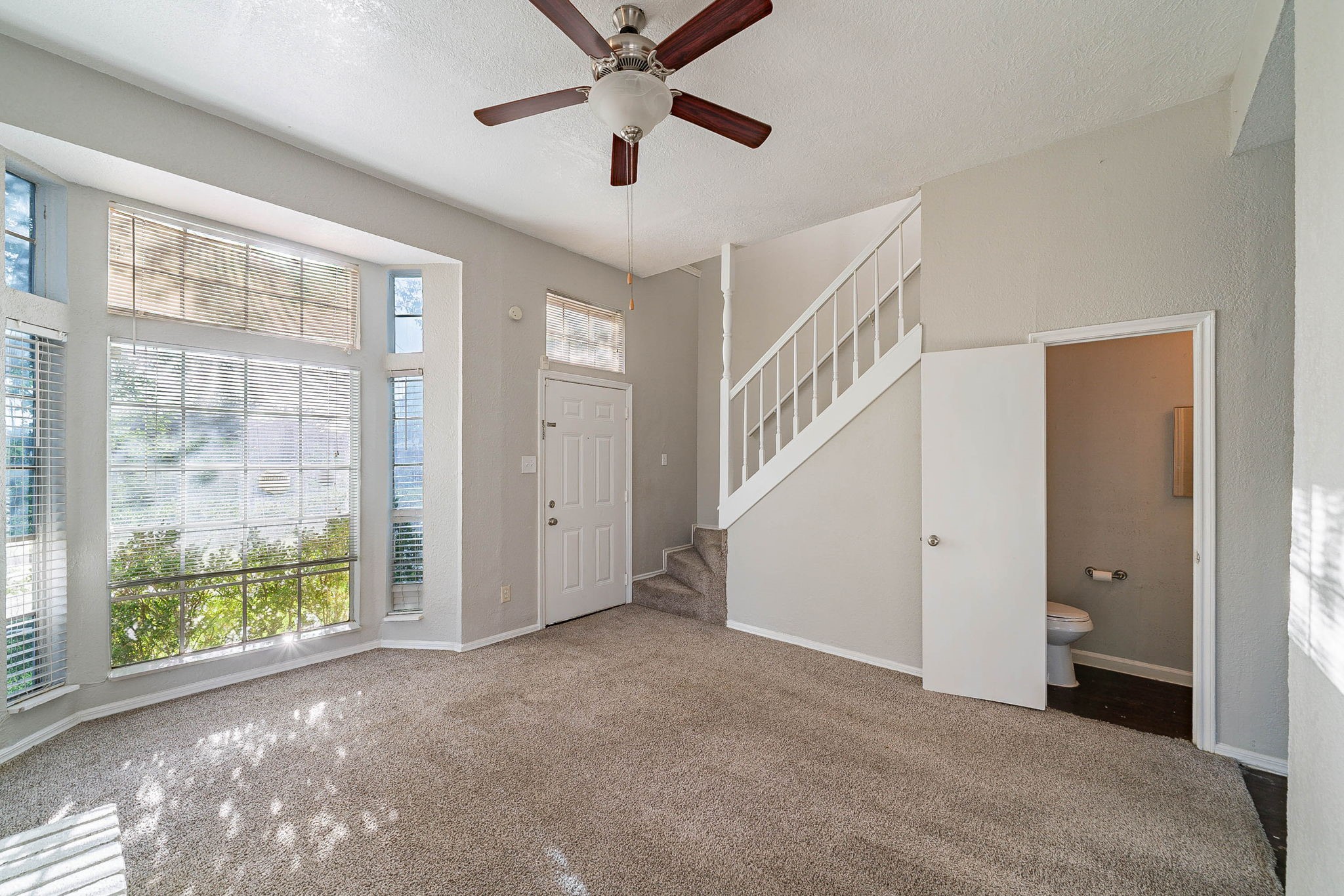 1502 Stevenage Lane Channelview, TX 77530 - Photo 7 of 33 a view of a room with a ceiling fan and windows