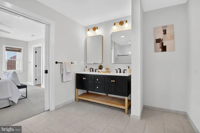 a spacious bathroom with a double vanity sink and a mirror