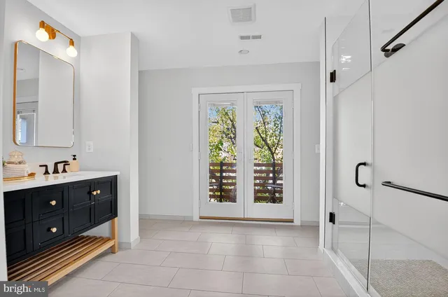 a bathroom with a sink a vanity and a mirror
