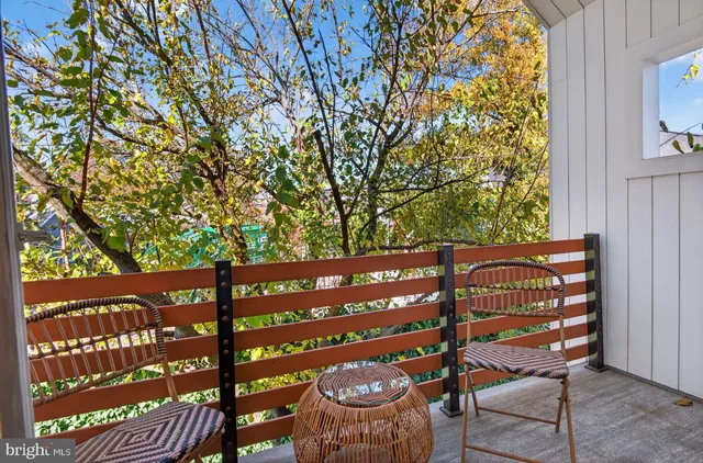 a wooden bench sitting in front of a building