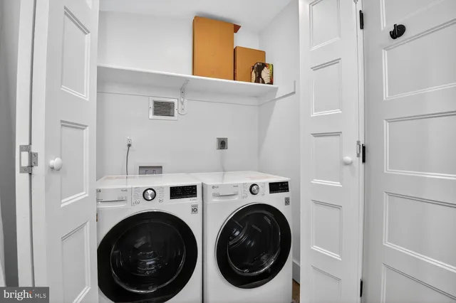 a view of a hallway with washer and dryer