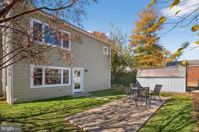 a view of a house with backyard and sitting area