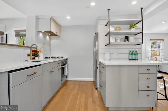 a kitchen with cabinets and window
