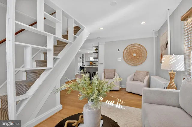 a living room with furniture and a clock