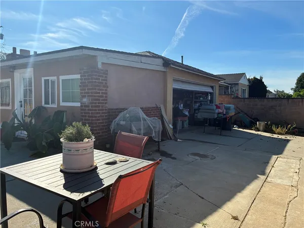 a view of a patio with table and chairs and potted plants