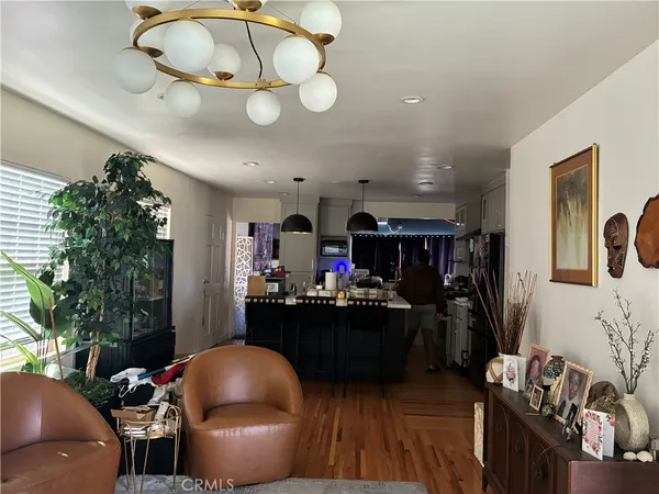a living room with furniture a chandelier and a window