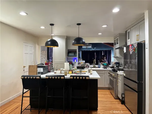 a kitchen with a stove a sink and a refrigerator