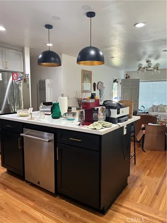 a view of a hallway with wooden floor and a bathroom