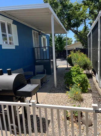 a view of a backyard with wooden fence