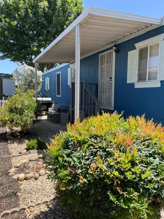 a front view of a house with a big yard