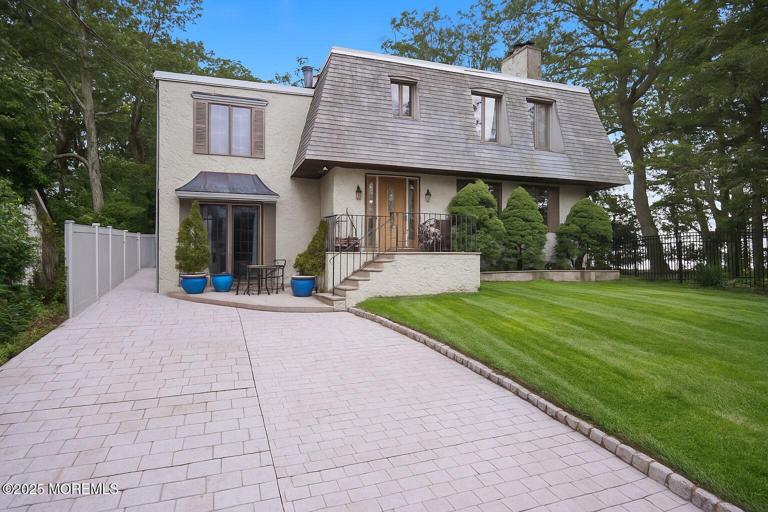 a view of a house with a yard and sitting area