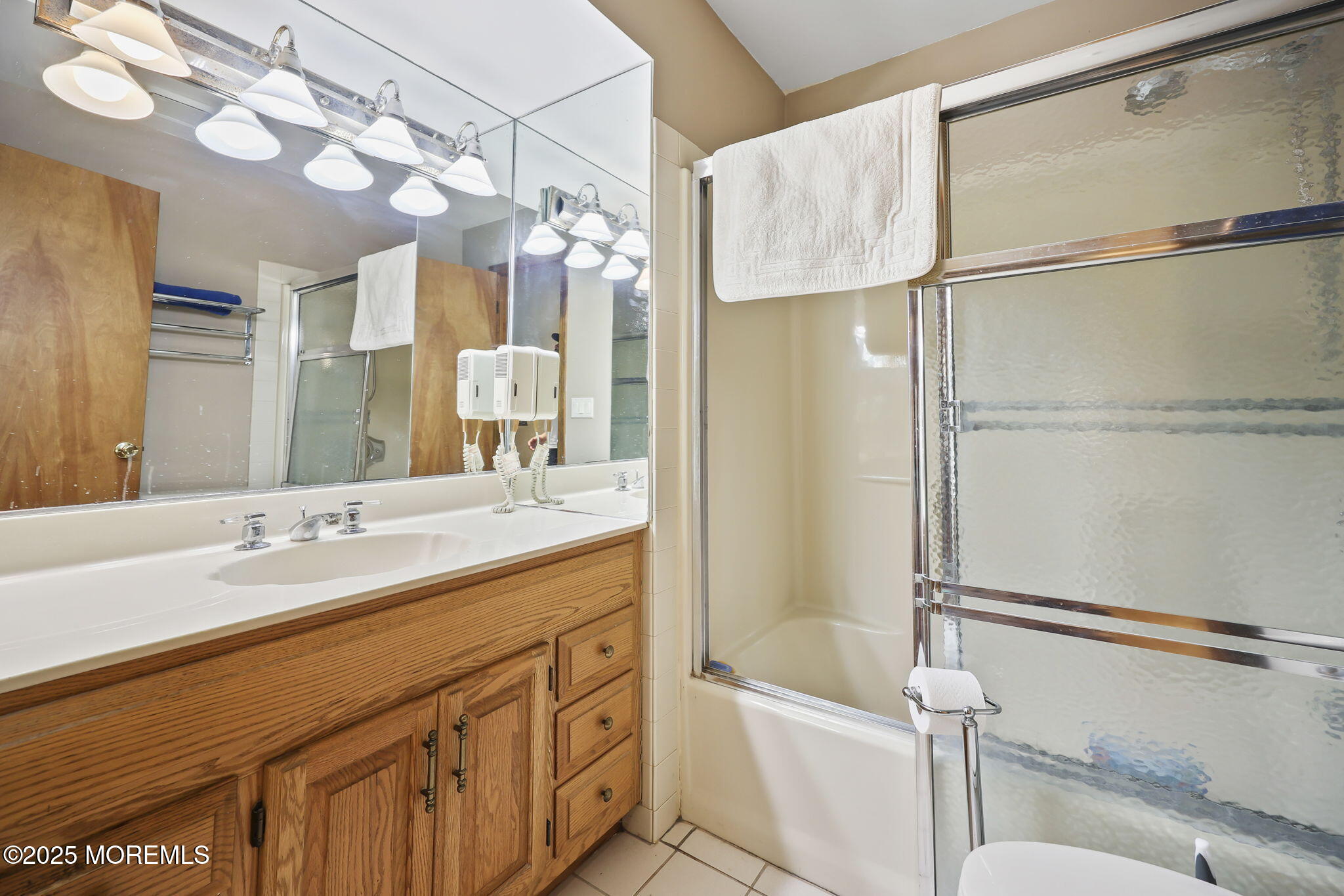 10 West Riverside Drive Brick, NJ 08723 - Photo 28 of 66 a bathroom with a granite countertop sink a mirror a bathtub and shower