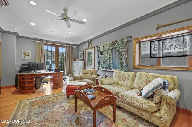 a living room with furniture ceiling fan and a rug