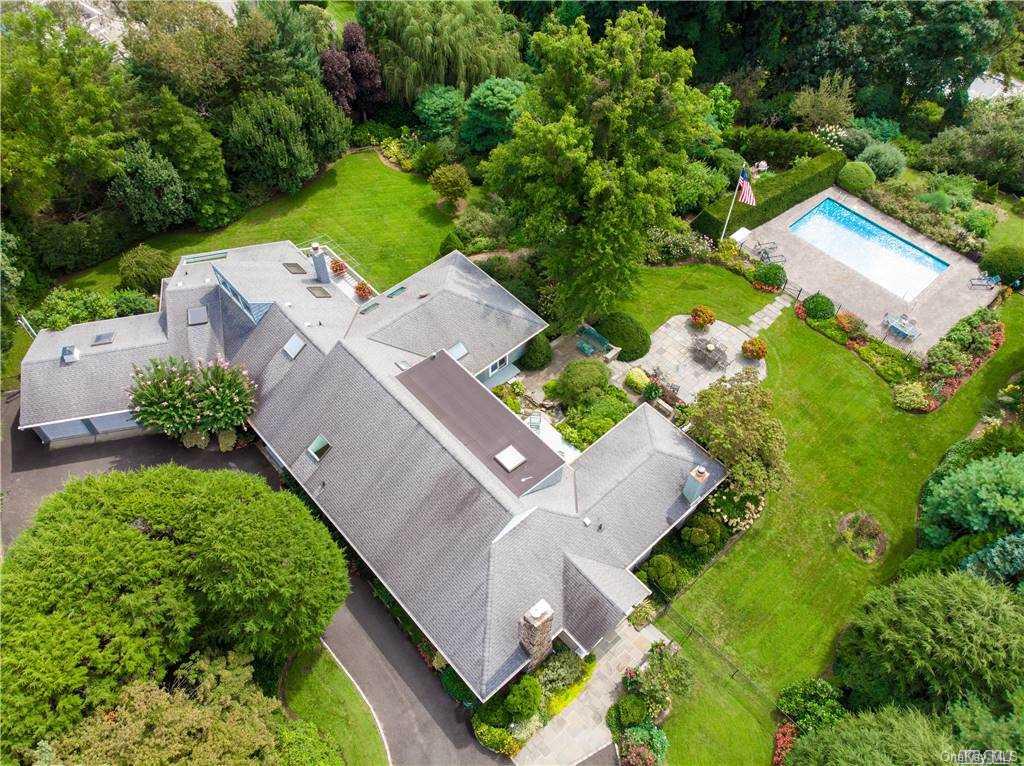 an aerial view of a house with a yard