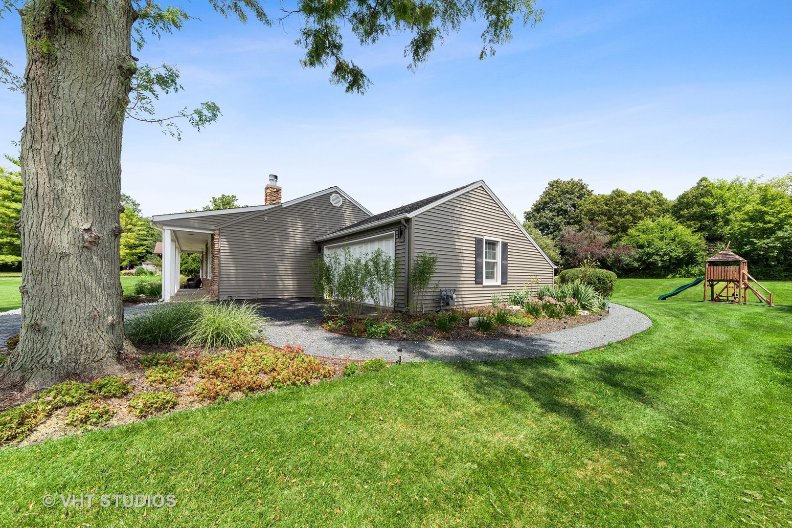 226 Valley Road Trout Valley, IL 60013 - Photo 26 of 32 a view of a house with a yard and potted plants