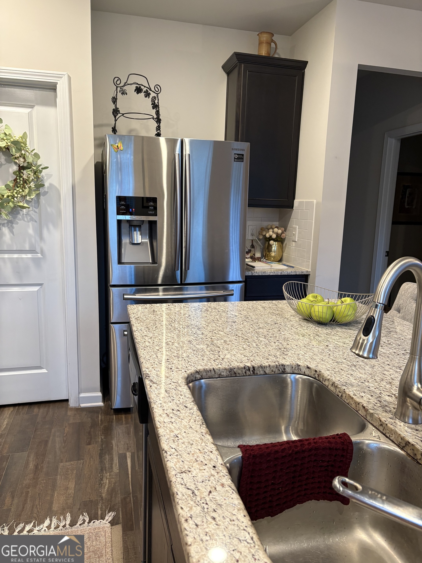 338 Lead Way Jonesboro, GA 30238 - Photo 13 of 17 a kitchen with kitchen island granite countertop a refrigerator a stove and a sink