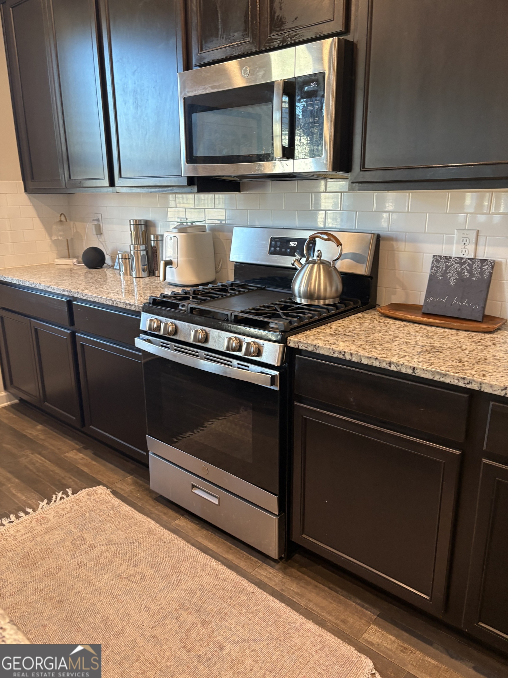 338 Lead Way Jonesboro, GA 30238 - Photo 14 of 17 a kitchen with stainless steel appliances granite countertop a stove and a microwave