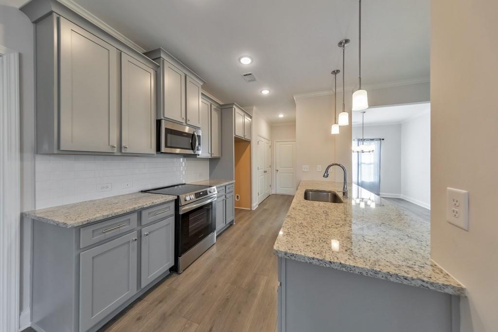 276 Brookstone Trail Dawsonville, GA 30534 - Photo 12 of 44 a kitchen with stainless steel appliances granite countertop a sink stove and microwave