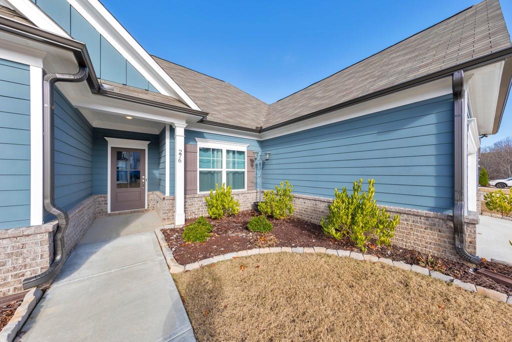 276 Brookstone Trail Dawsonville, GA 30534 - Photo 2 of 44 a front view of a house with garden