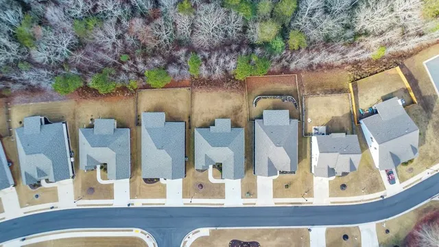 a view of a house with pool and chairs