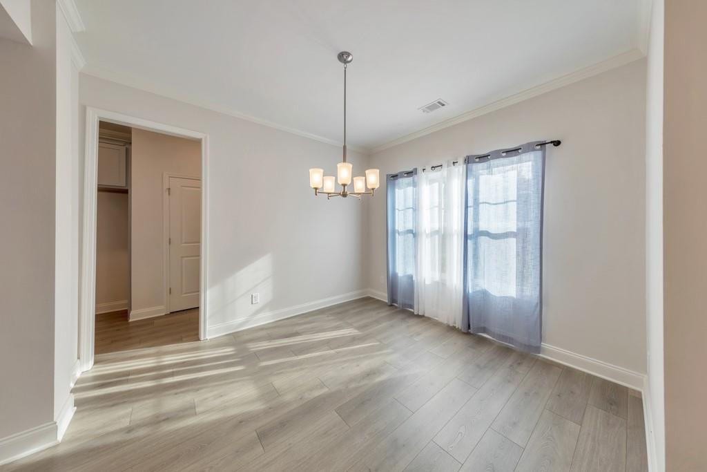 276 Brookstone Trail Dawsonville, GA 30534 - Photo 4 of 44 a view of a livingroom with a chandelier fan and windows