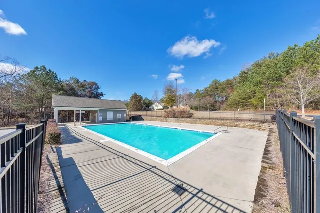 a picture of a bathroom with a white wall
