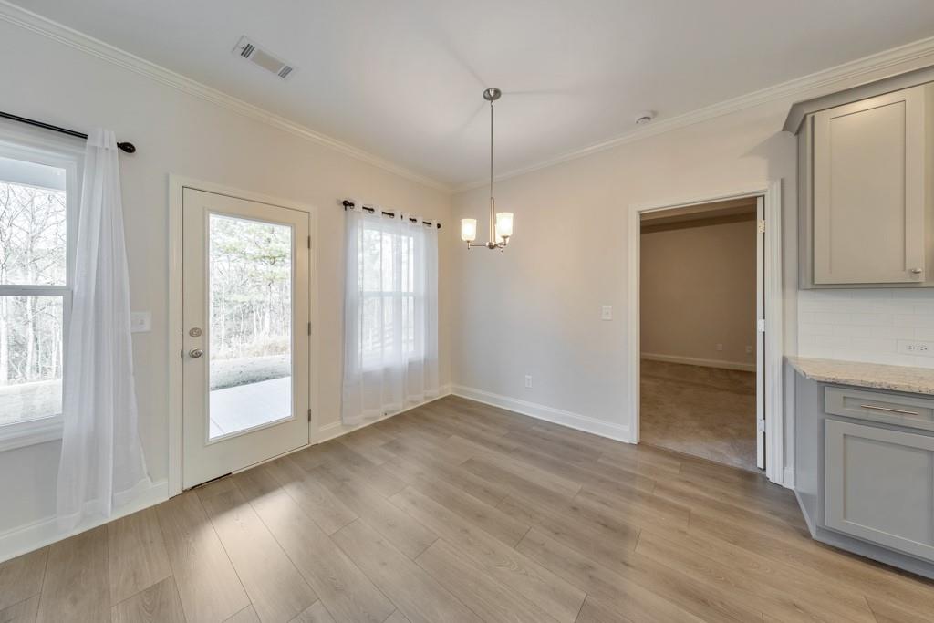 276 Brookstone Trail Dawsonville, GA 30534 - Photo 10 of 44 a view of an empty room with window and wooden floor