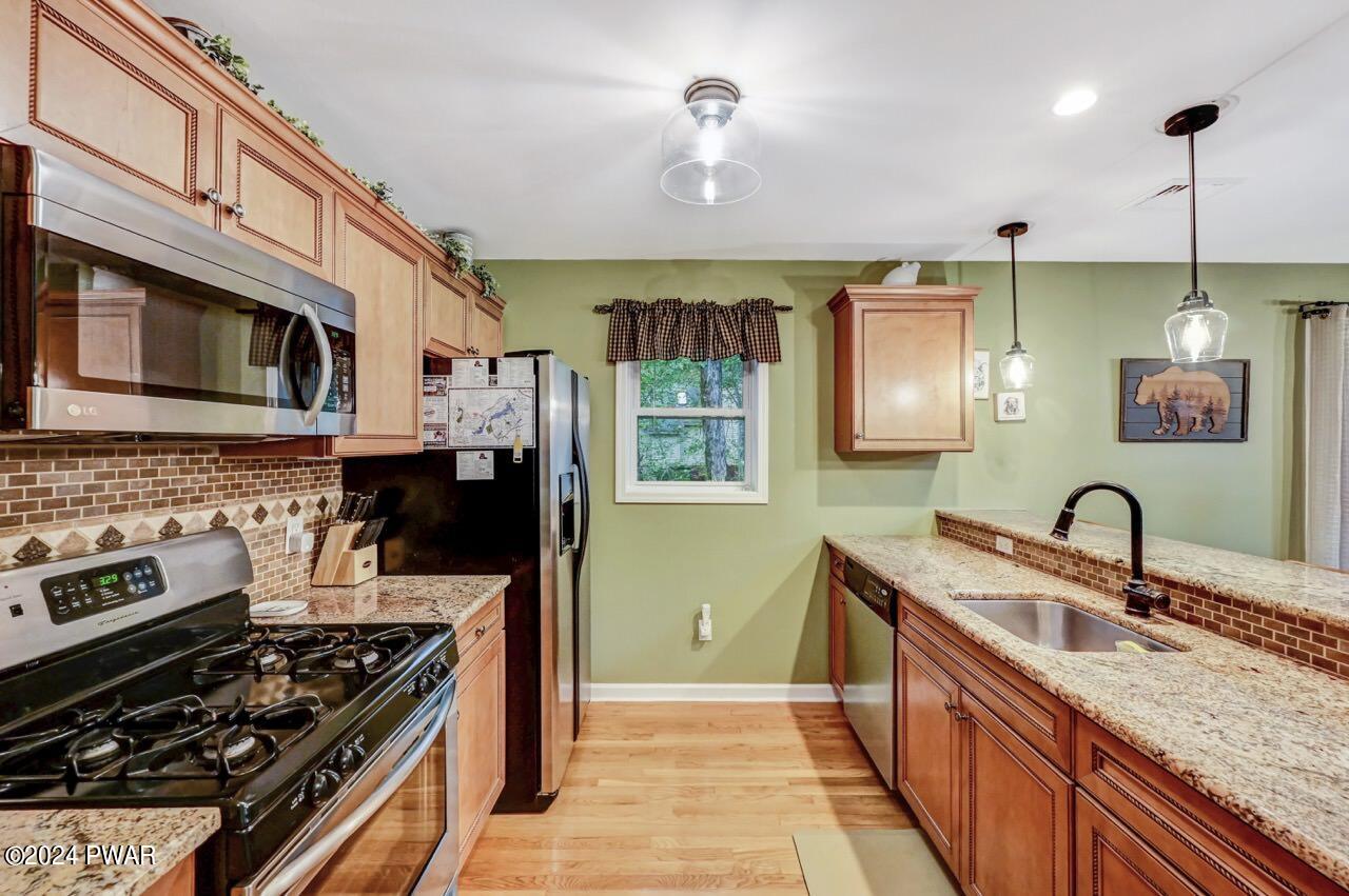 3295 Northgate Road Lake Ariel, PA 18436 - Photo 17 of 111 a kitchen with stainless steel appliances granite countertop a stove a sink and a microwave