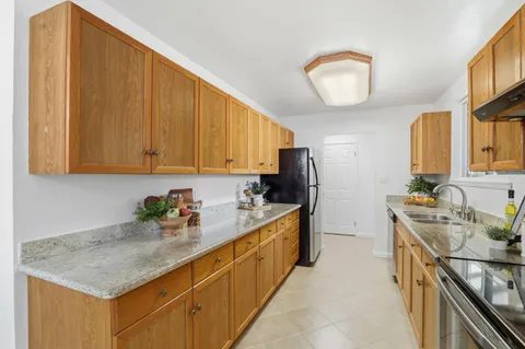 a kitchen with sink cabinets and appliances