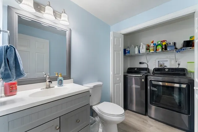 a bathroom with a sink a toilet and a mirror