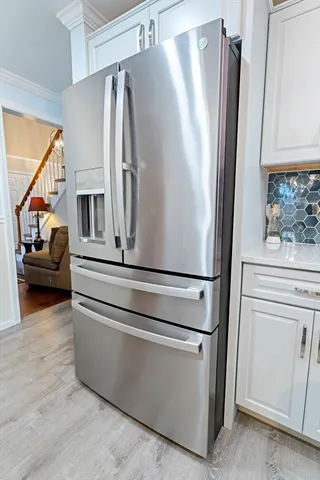 a view of kitchen with stainless steel appliances and refrigerator