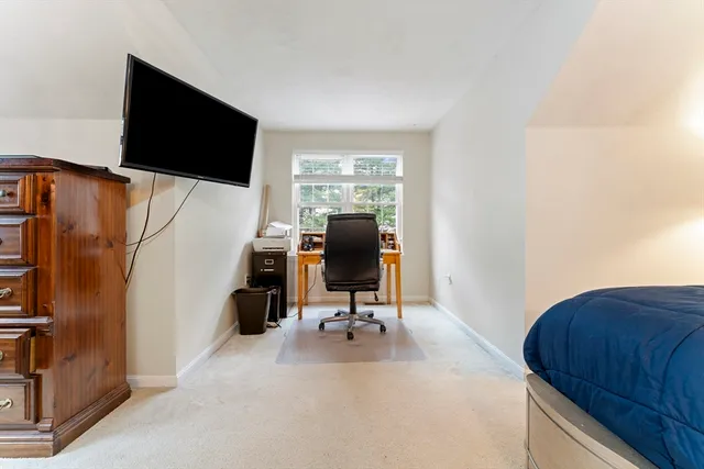 a view of a workspace with furniture and a window