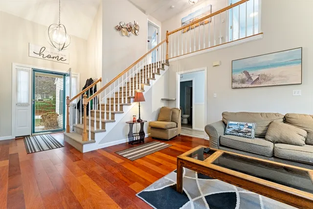 a living room with furniture and a table with wooden floor