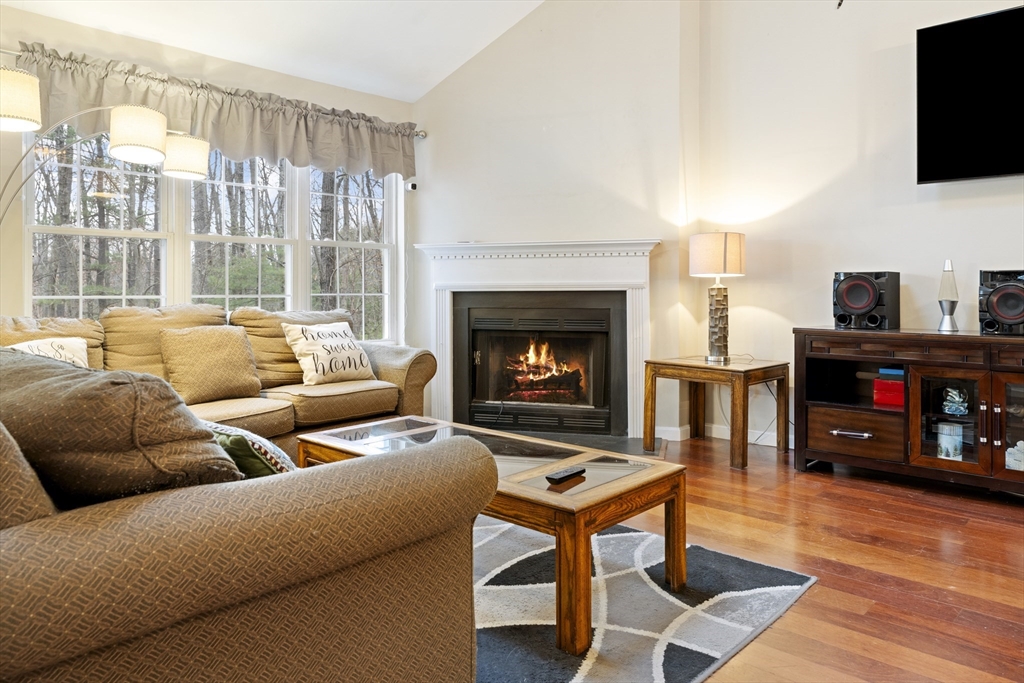 7 Millers Way, Unit C Sutton, MA 01590 - Photo 8 of 28 a living room with furniture a flat screen tv and a fireplace