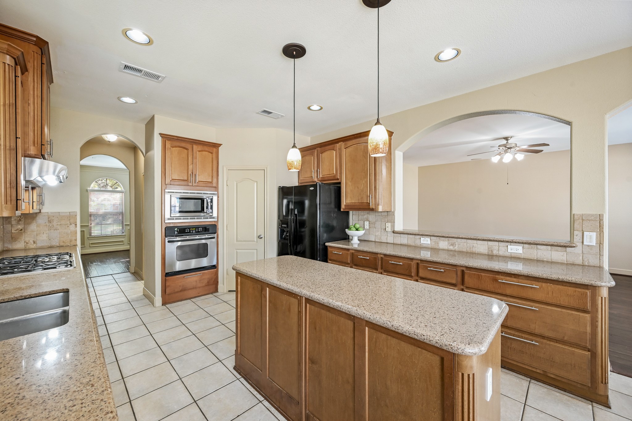 12527 Cape Sable Court Humble, TX 77346 - Photo 17 of 39 a large kitchen with stainless steel appliances a large counter top a stove and a refrigerator