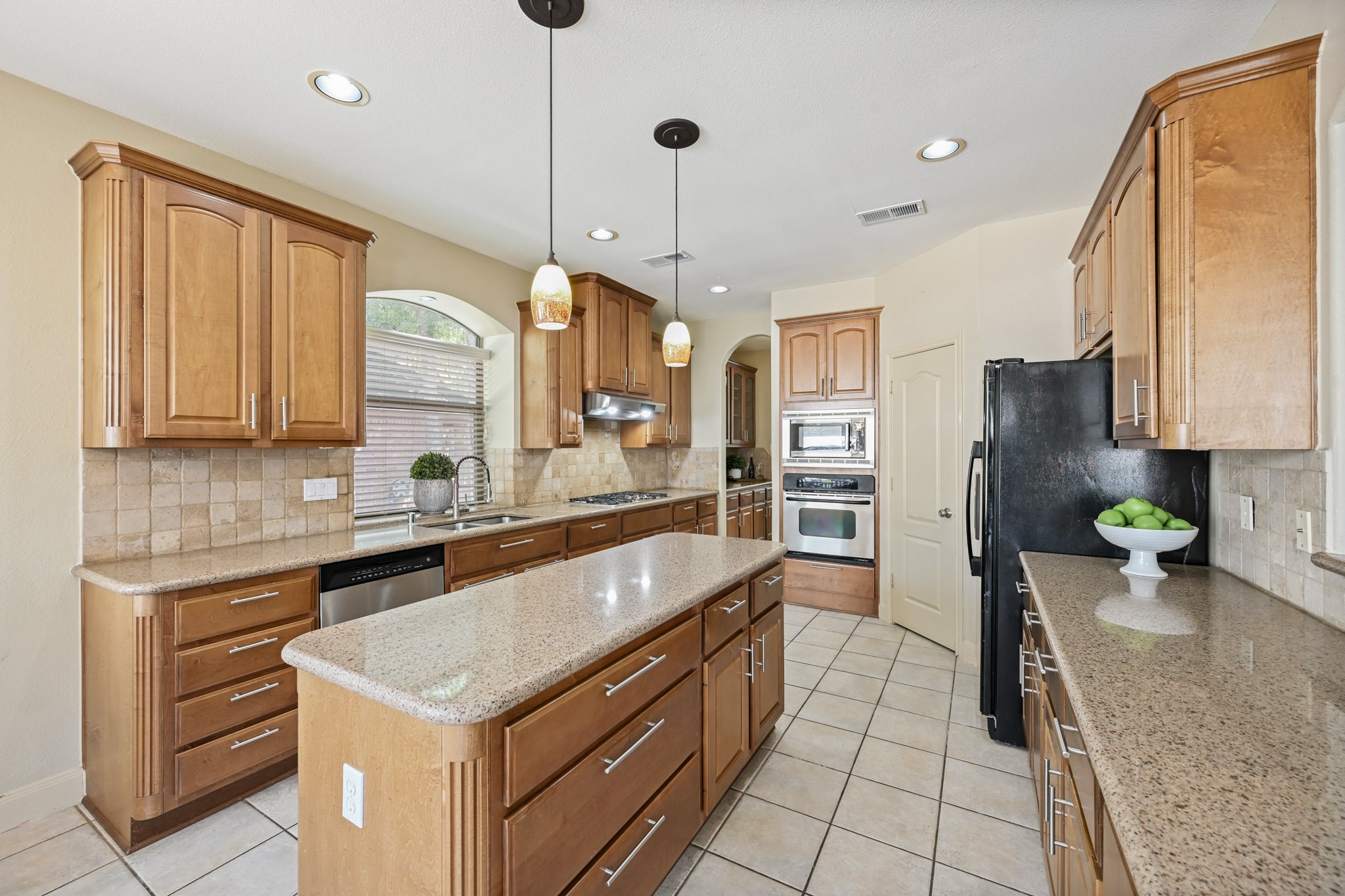 12527 Cape Sable Court Humble, TX 77346 - Photo 18 of 39 a kitchen with stainless steel appliances granite countertop a sink and a refrigerator