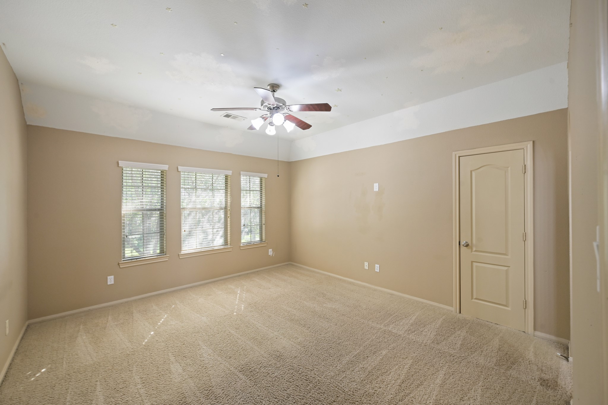 12527 Cape Sable Court Humble, TX 77346 - Photo 33 of 39 an empty room with chandelier fan and windows