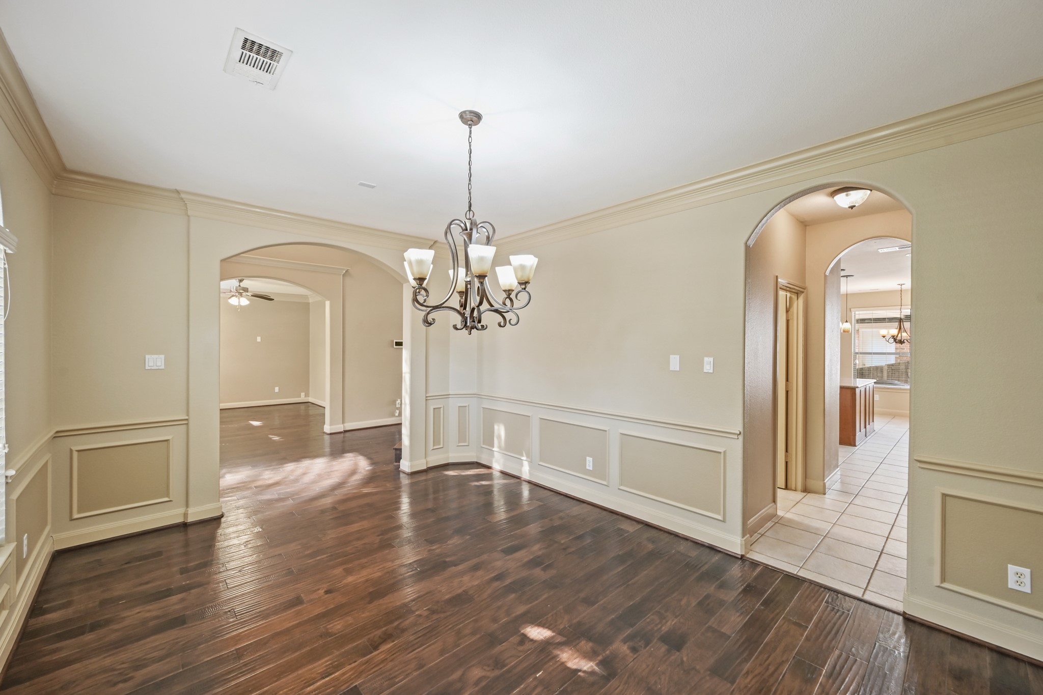 12527 Cape Sable Court Humble, TX 77346 - Photo 8 of 39 a view of a hallway with wooden floor and chandelier