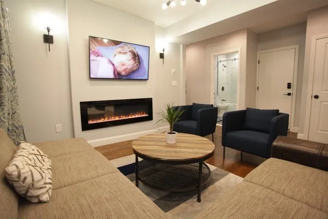 a living room with furniture and a fireplace