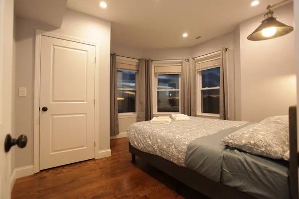 a bedroom with a bed and a lamp