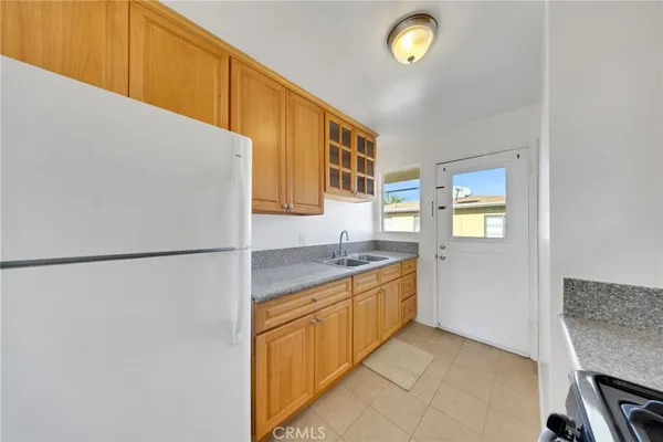 a view of a kitchen with a sink and a refrigerator