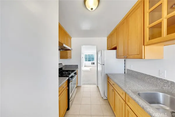a kitchen with a sink and a refrigerator