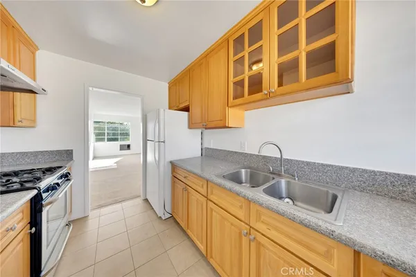 a kitchen with stainless steel appliances granite countertop a sink and a stove