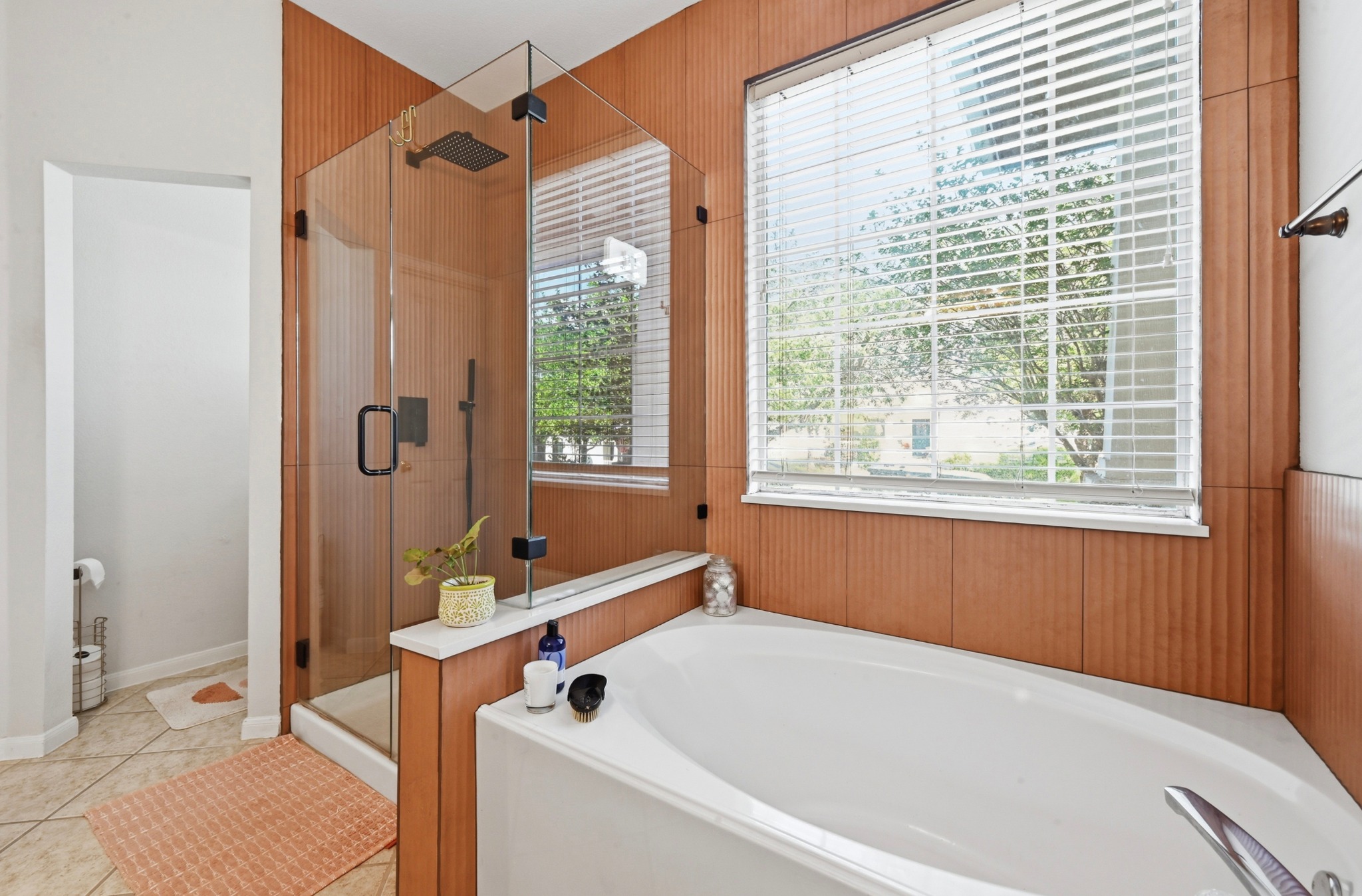 5888 Fergus Kyle, TX 78640 - Photo 16 of 40 Indulge in a tranquil bathing experience with a spacious soaking tub and a sleek glass-enclosed shower.